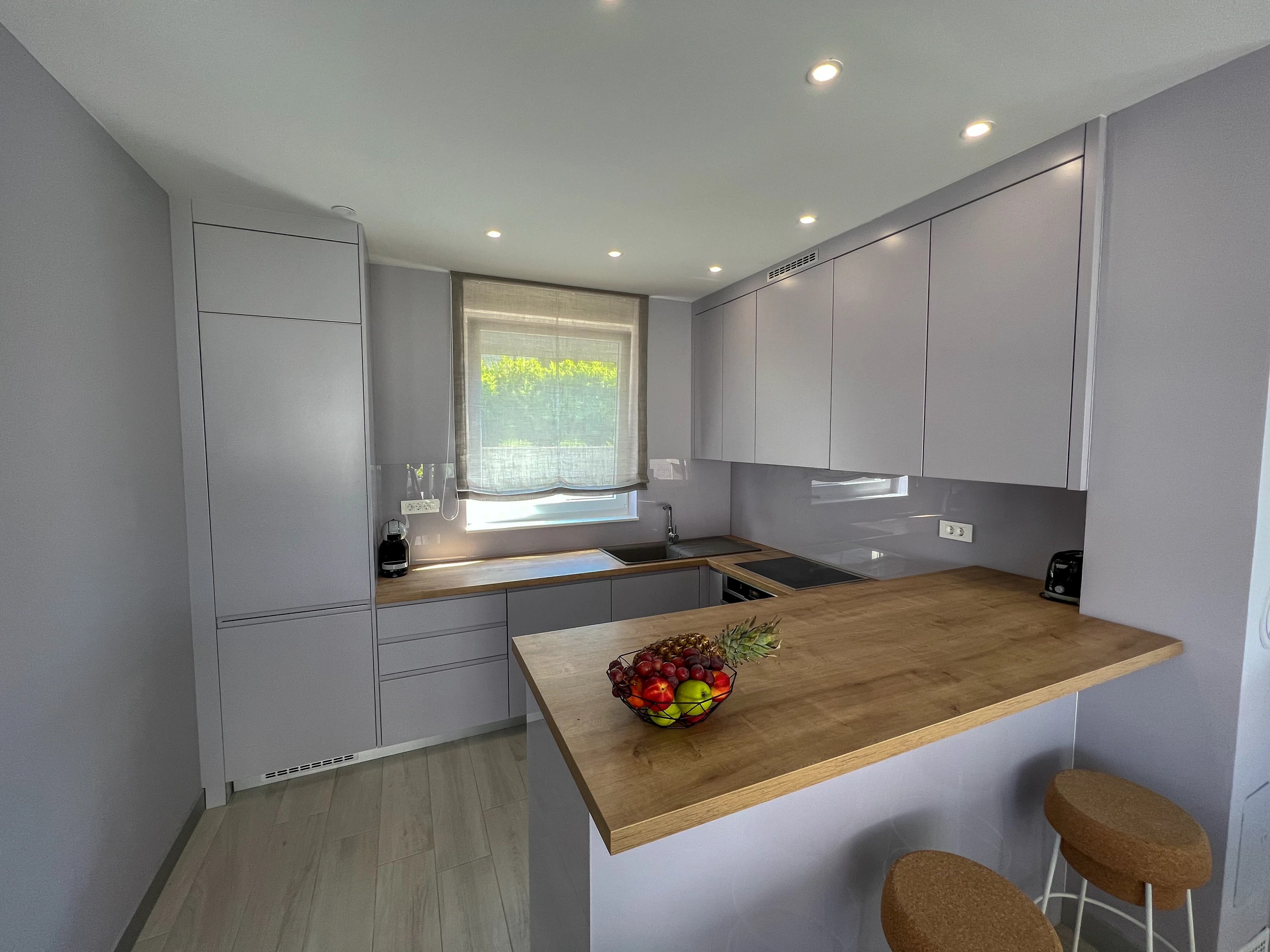 Kitchen island and living area at Three-Bedroom Premium Apartment Near the Sea