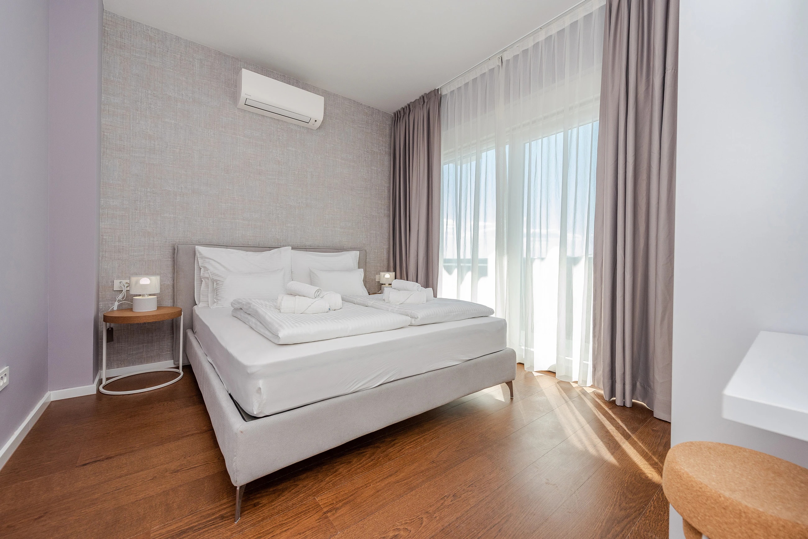Double bedroom with balcony doors at Three-Bedroom Premium Apartment Near the Sea