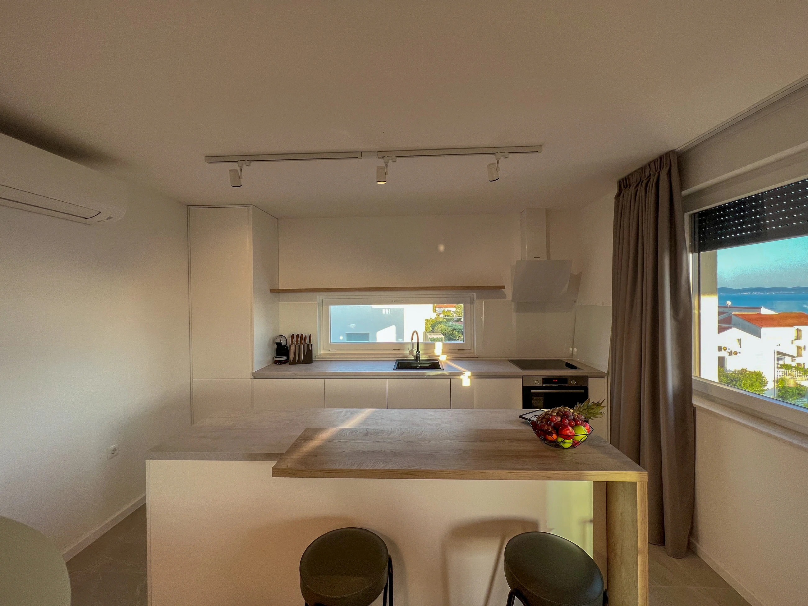Bright contemporary kitchen at Three-Bedroom Apartment Near the Sea