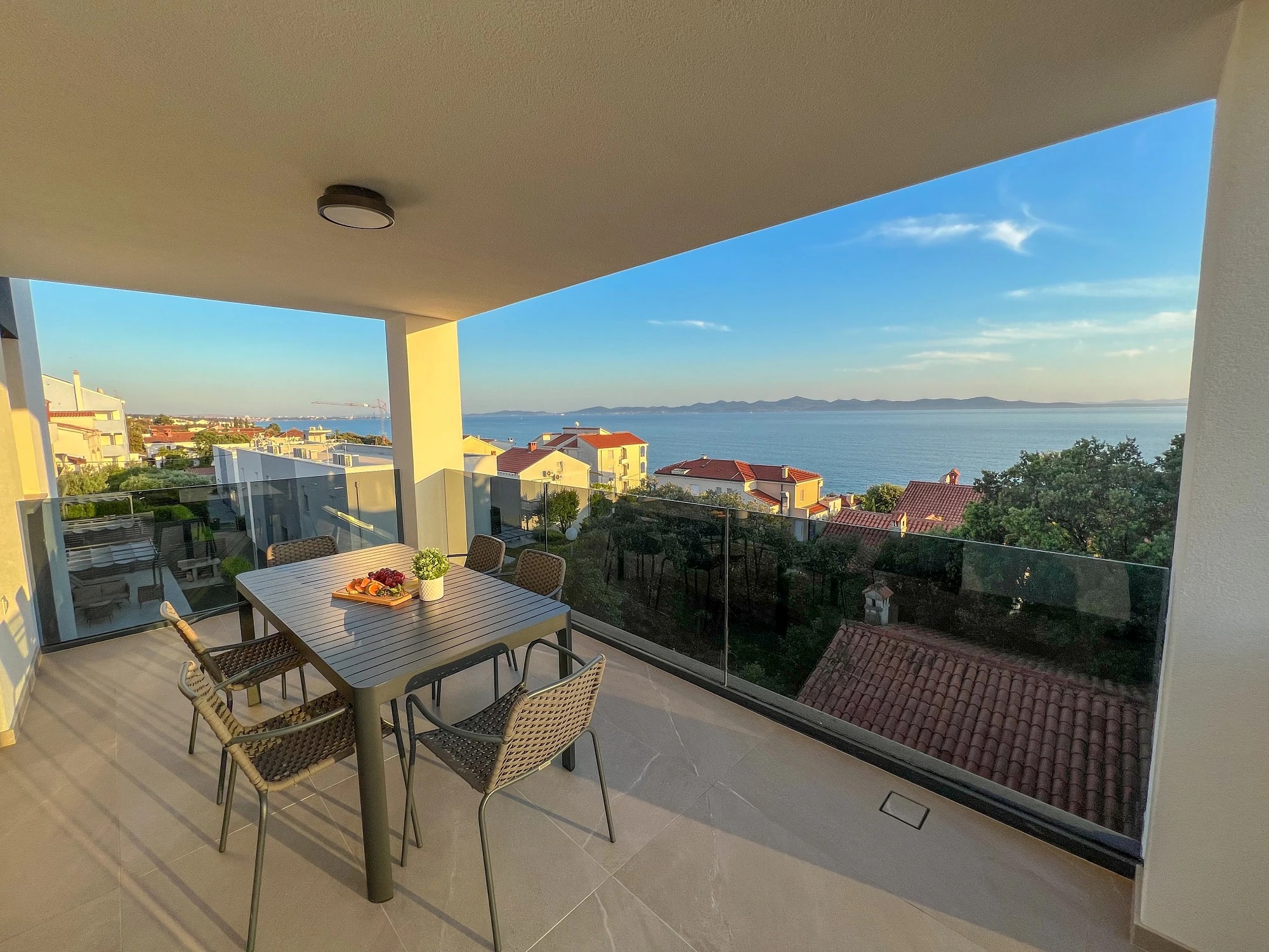 Sea-view balcony with an outdoor dining table at Three-Bedroom Apartment Near the Sea