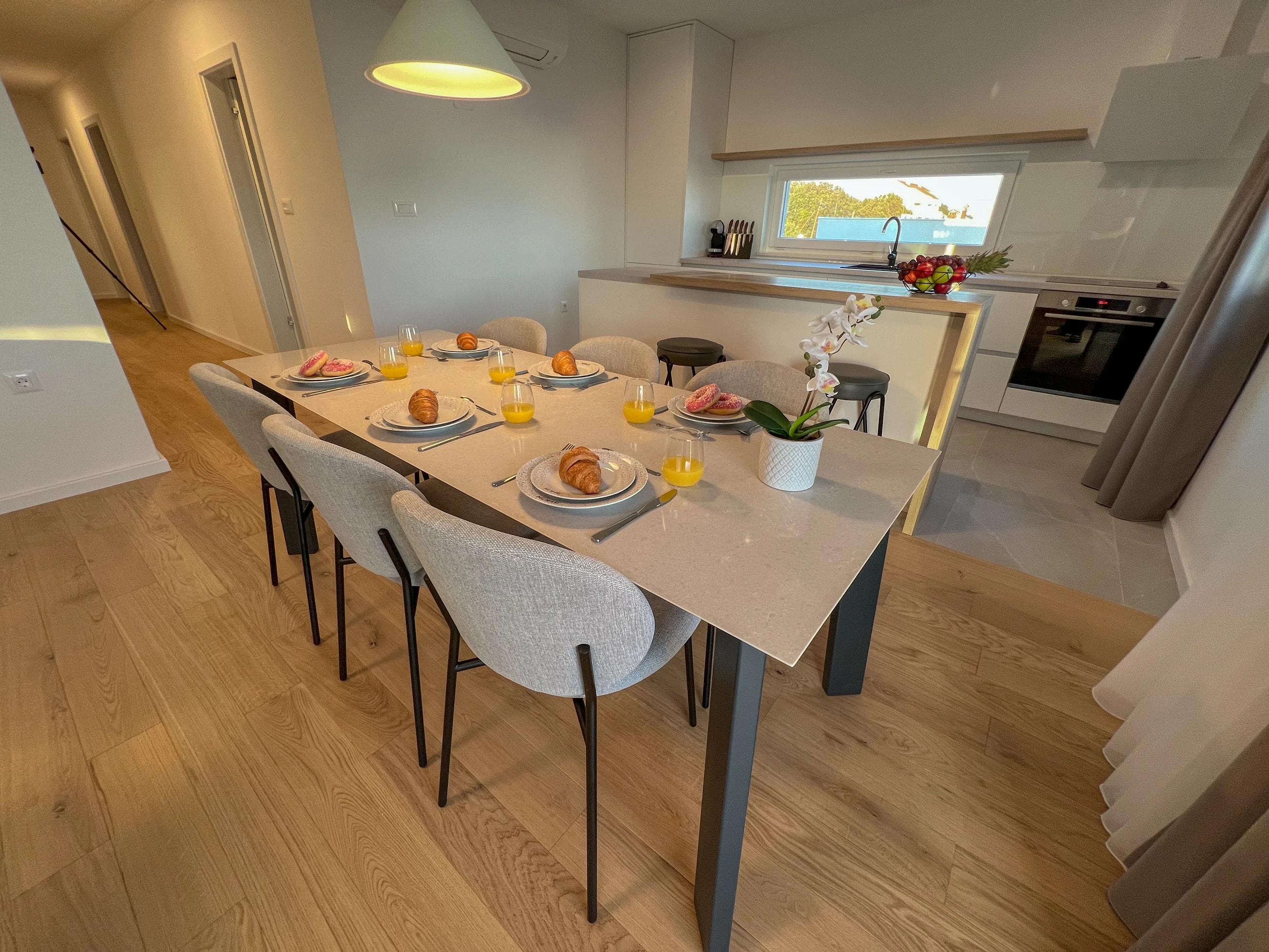Dining table beside the kitchen at Three-Bedroom Apartment Near the Sea