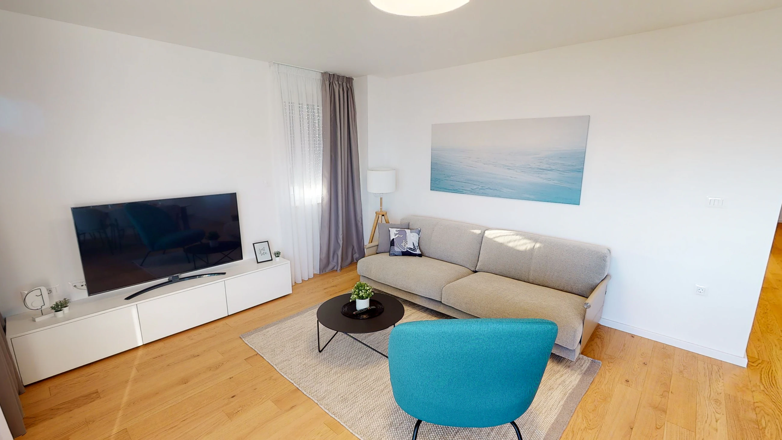 Living room with sea-inspired artwork at Three-Bedroom Apartment Near the Sea