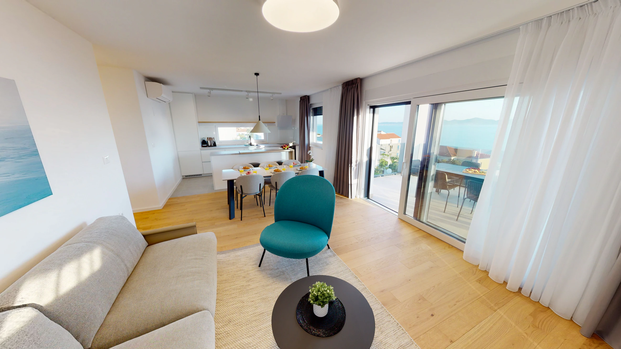 Living area opening onto the balcony at Three-Bedroom Apartment Near the Sea