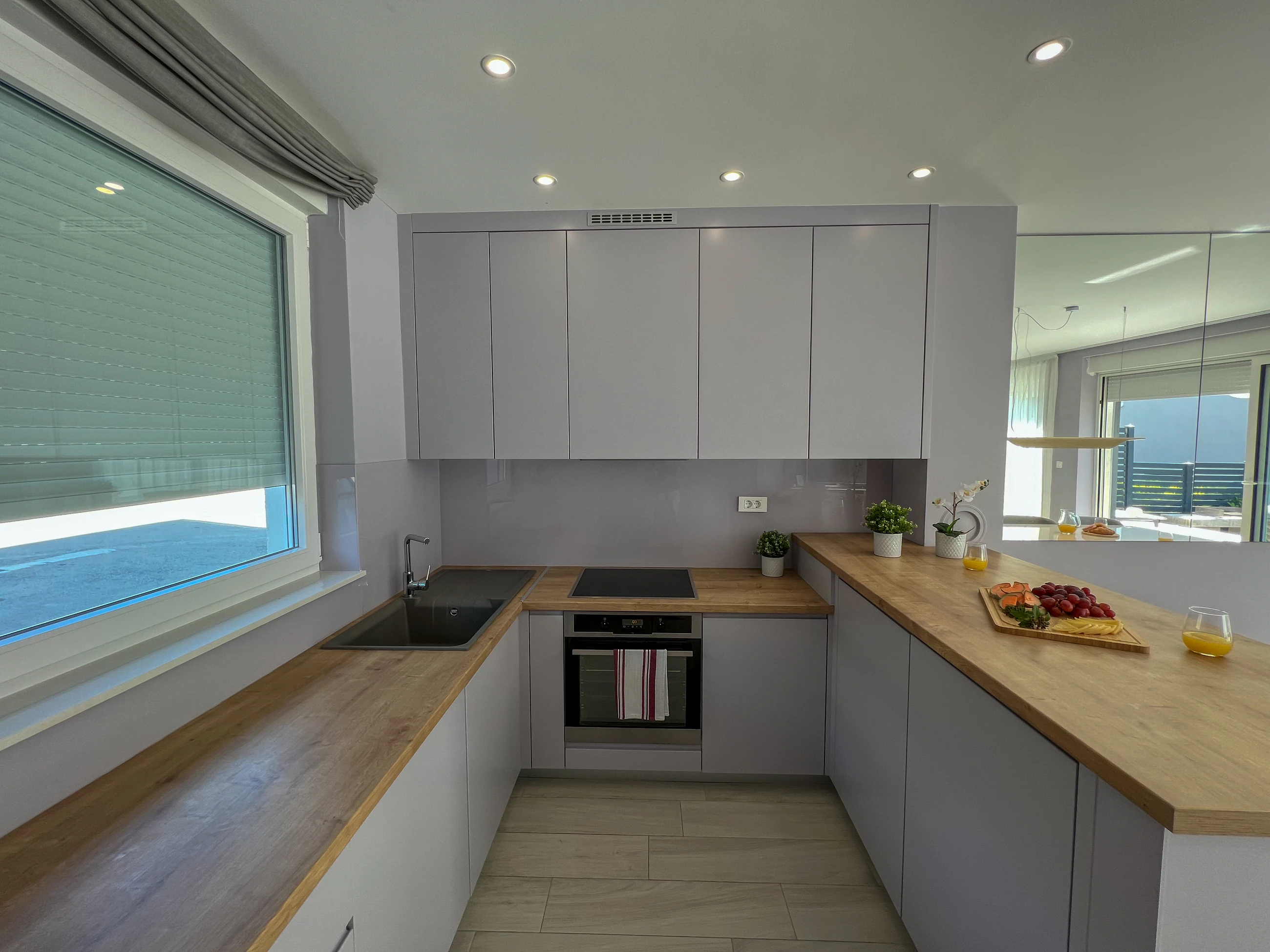 Fully equipped contemporary kitchen at Three-Bedroom Apartment with Private Pool Near the Sea