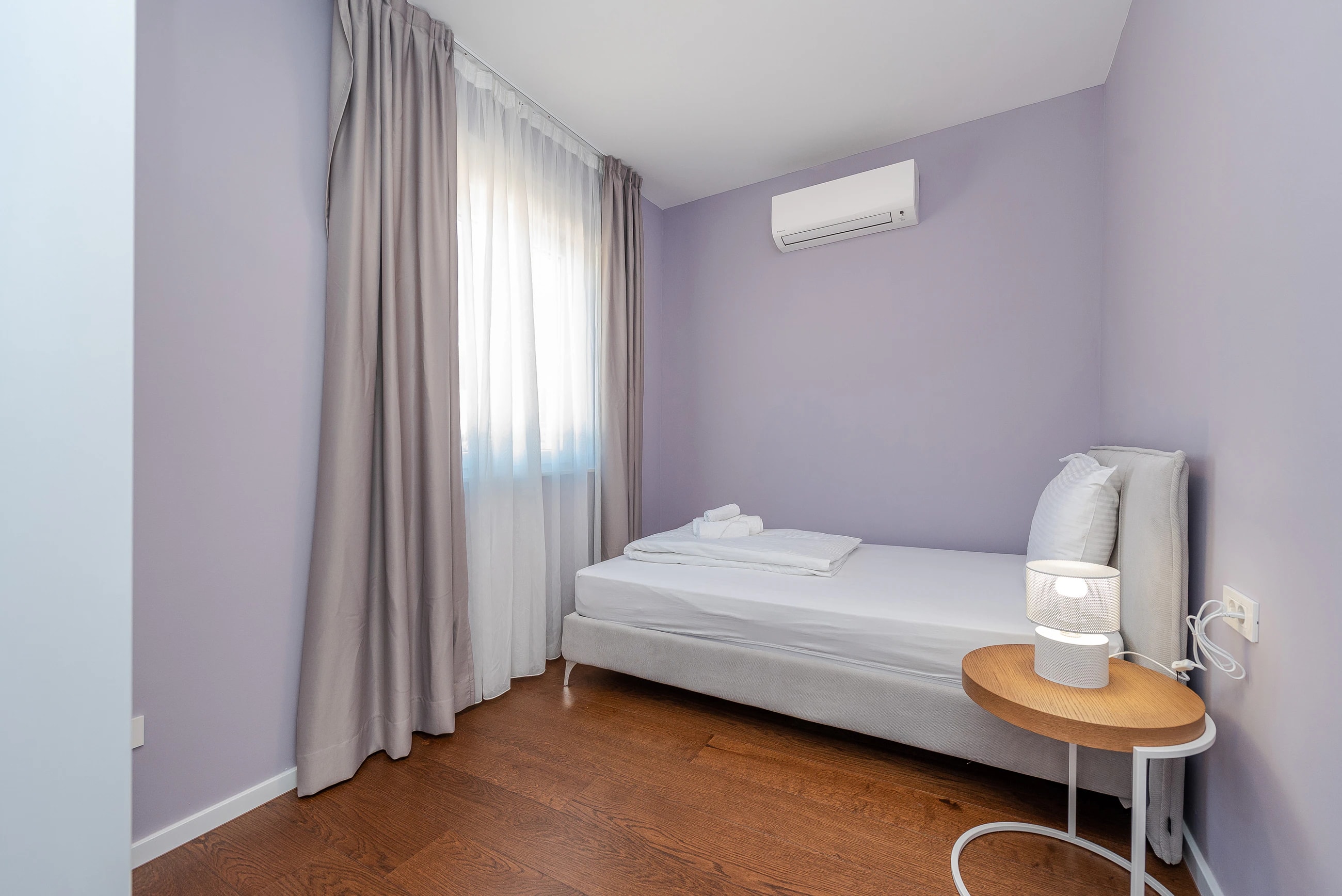 Twin bedroom in soft neutral tones at Three-Bedroom Apartment with Private Pool Near the Sea