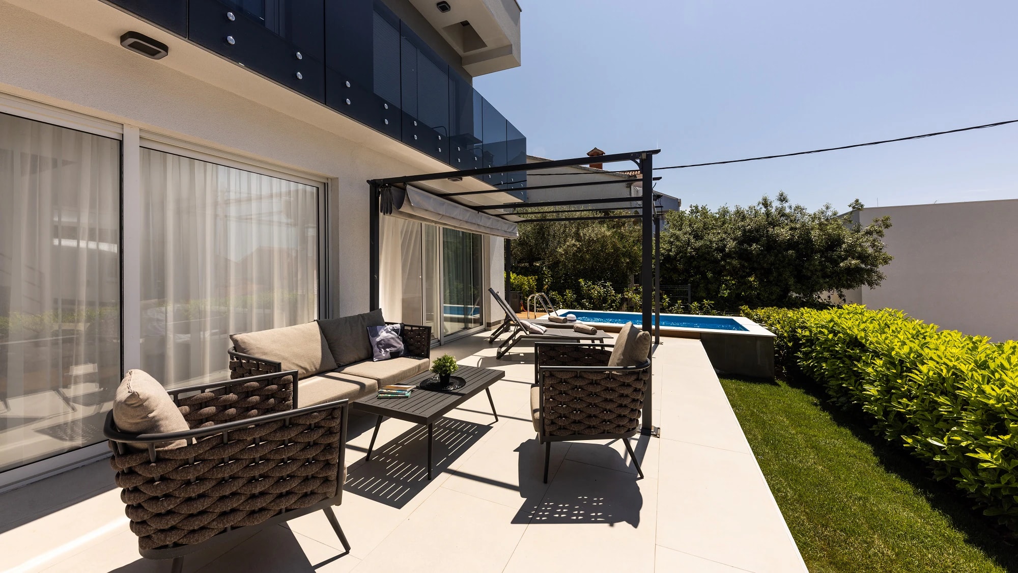 Furnished pool terrace beside the apartment at Three-Bedroom Apartment with Private Pool Near the Sea