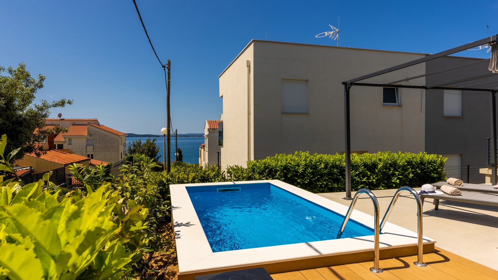 Private pool with a glimpse of the Adriatic at Three-Bedroom Apartment with Private Pool Near the Sea