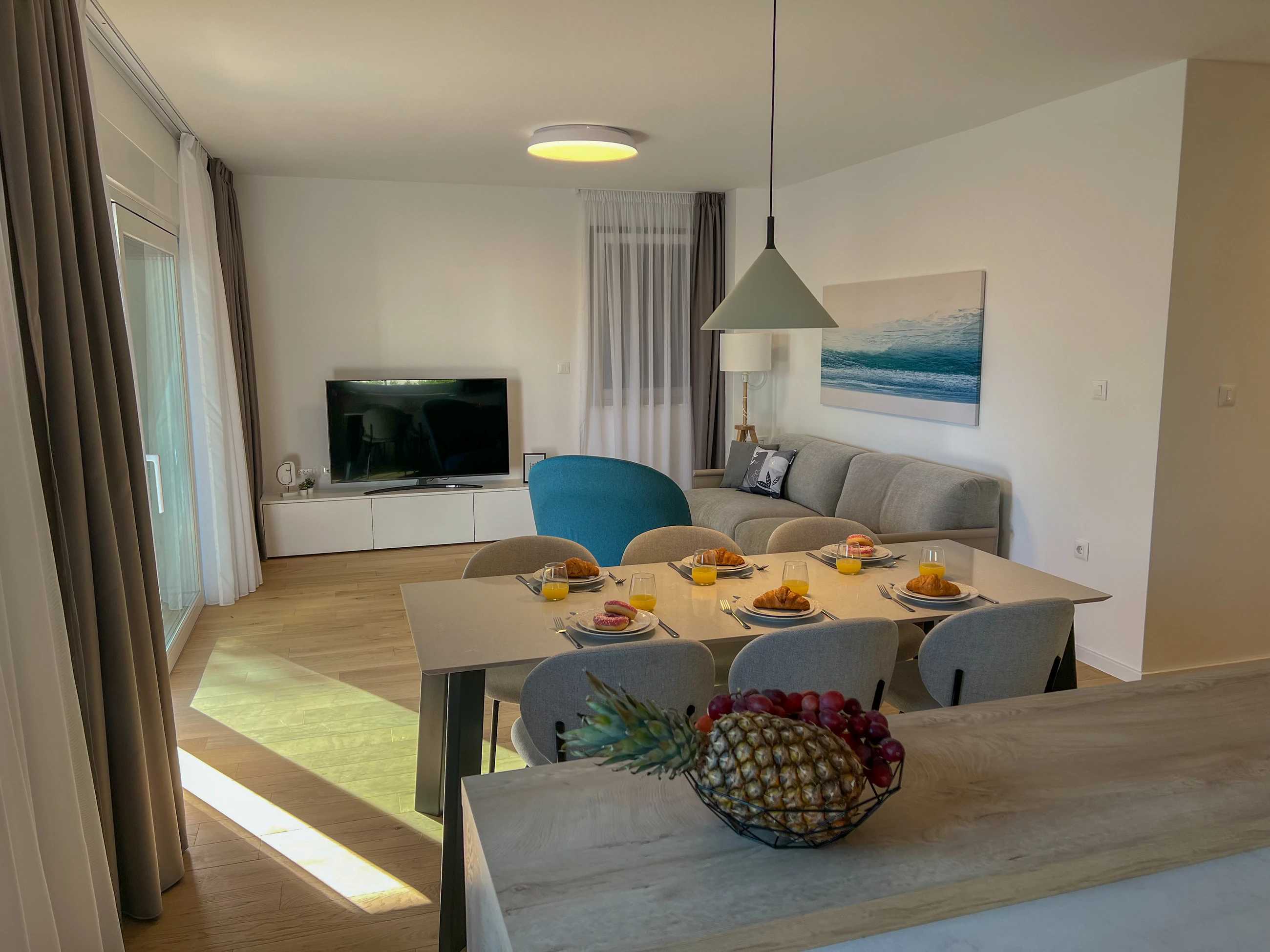 Dining and living room with garden doors at Three-Bedroom Apartment with Private Pool Near the Sea