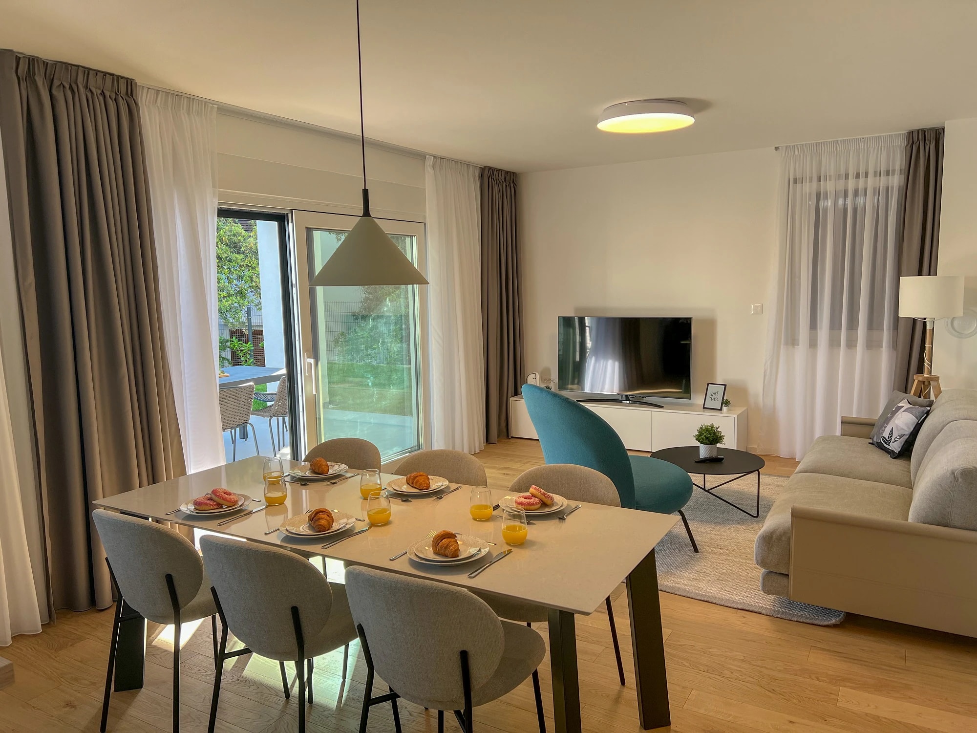 Dining table in the open living space at Three-Bedroom Apartment with Private Pool Near the Sea