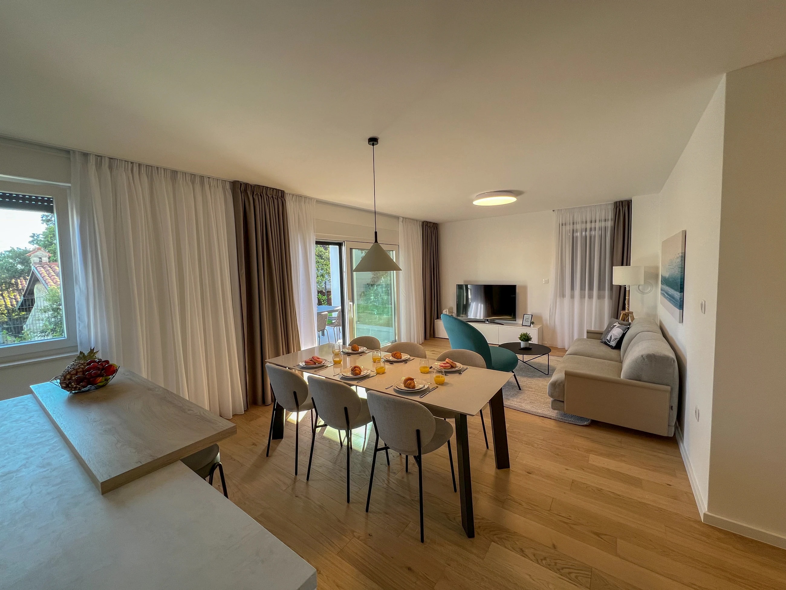 Wide view of the dining and living room at Three-Bedroom Apartment with Private Pool Near the Sea