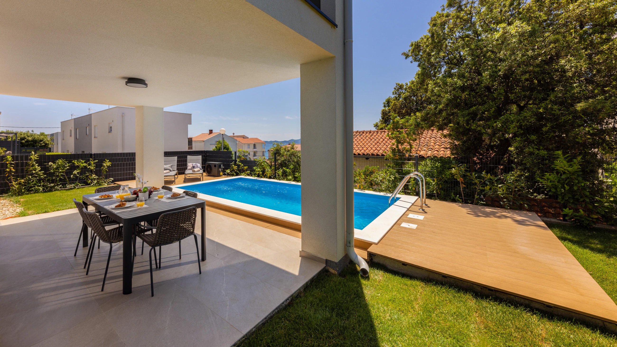 Covered outdoor dining beside the pool at Three-Bedroom Apartment with Private Pool Near the Sea