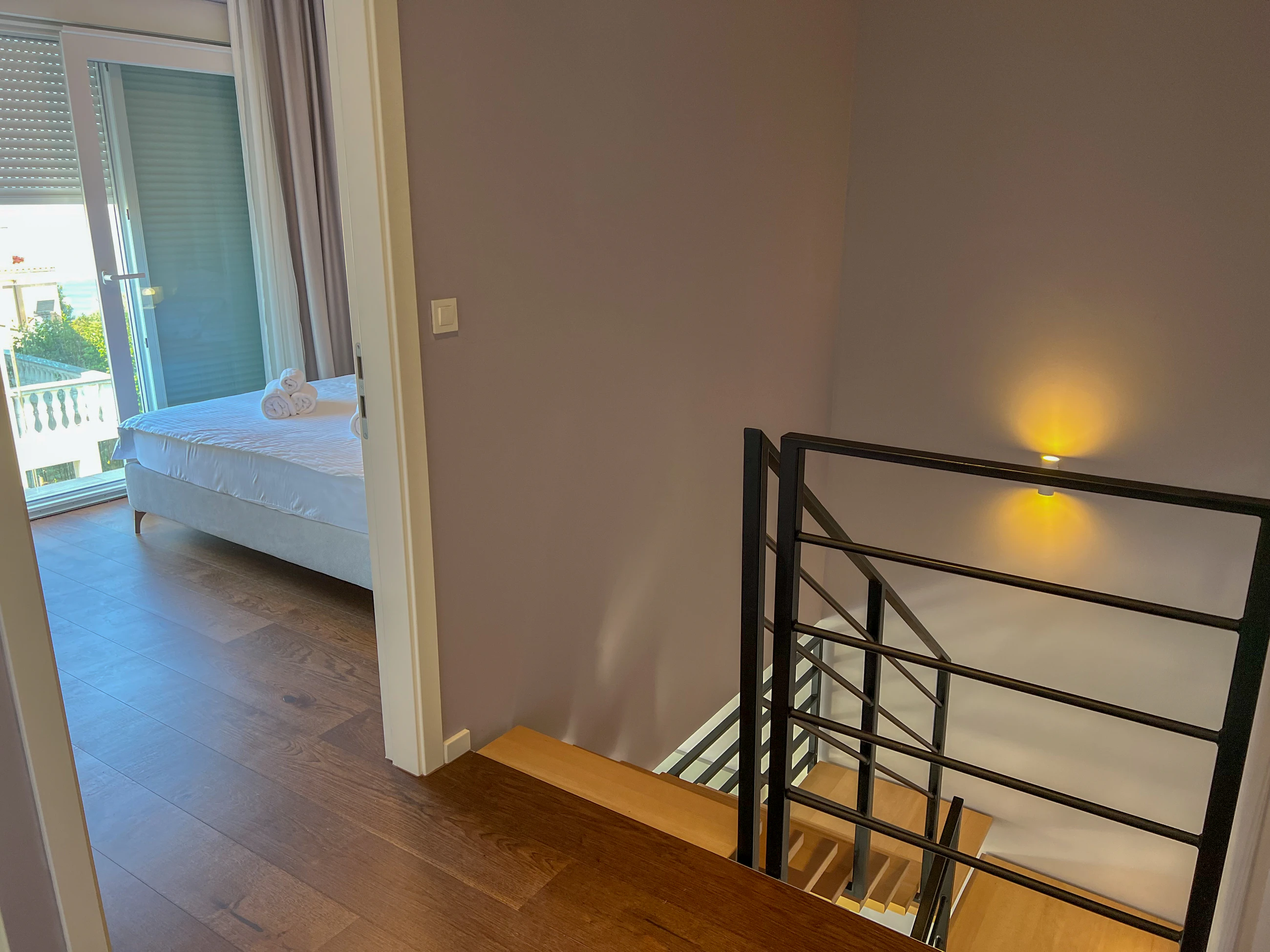 Stair landing between the bedrooms at Three-Bedroom Apartment with Private Pool Near the Sea