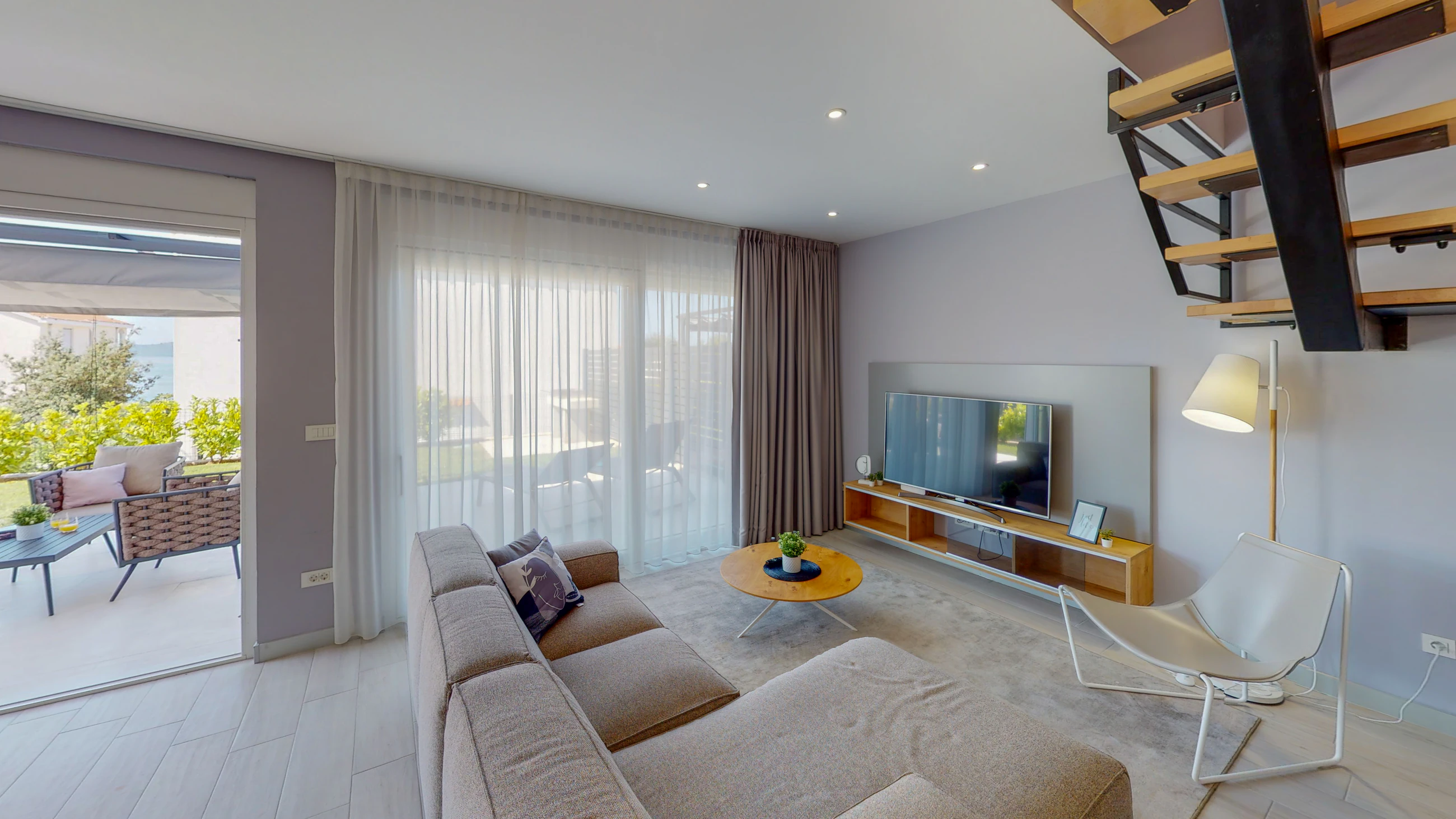 Living room beside the terrace doors at Three-Bedroom Apartment with Private Pool Near the Sea