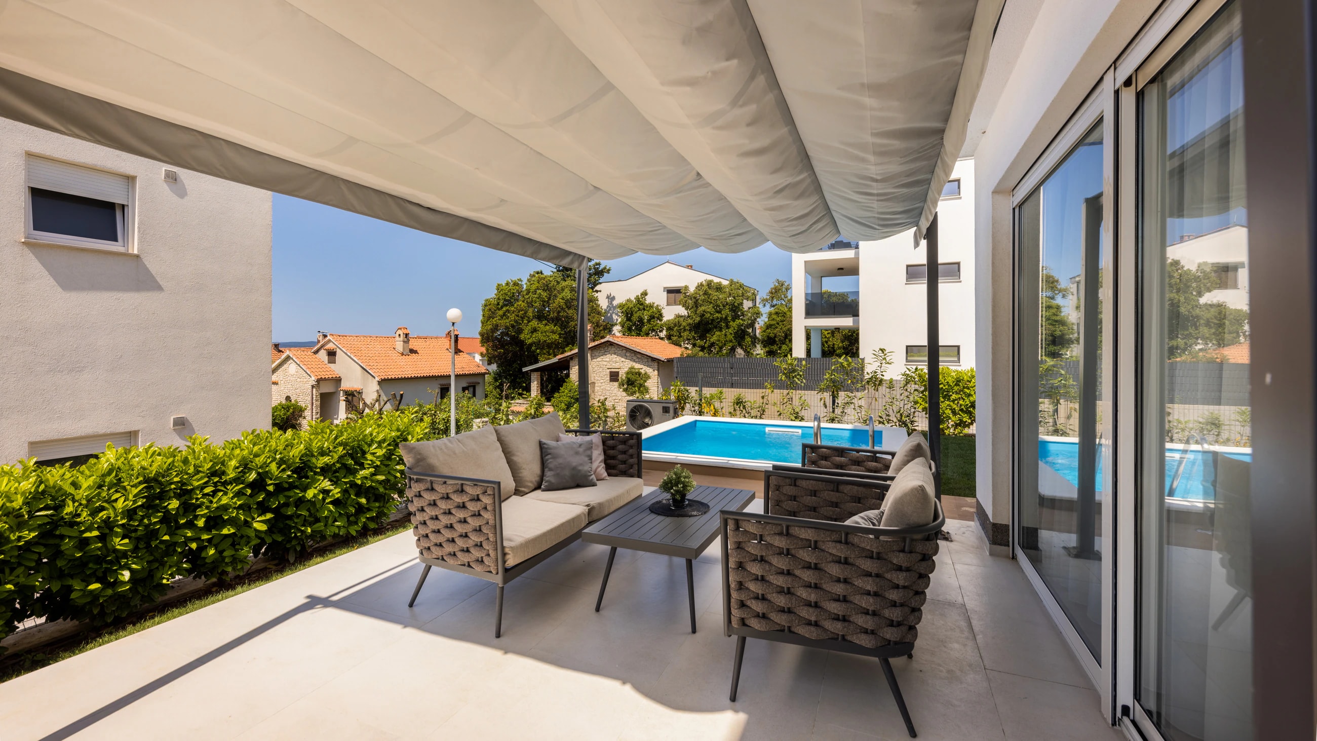 Covered outdoor lounge beside the private pool at Three-Bedroom Apartment with Private Pool Near the Sea
