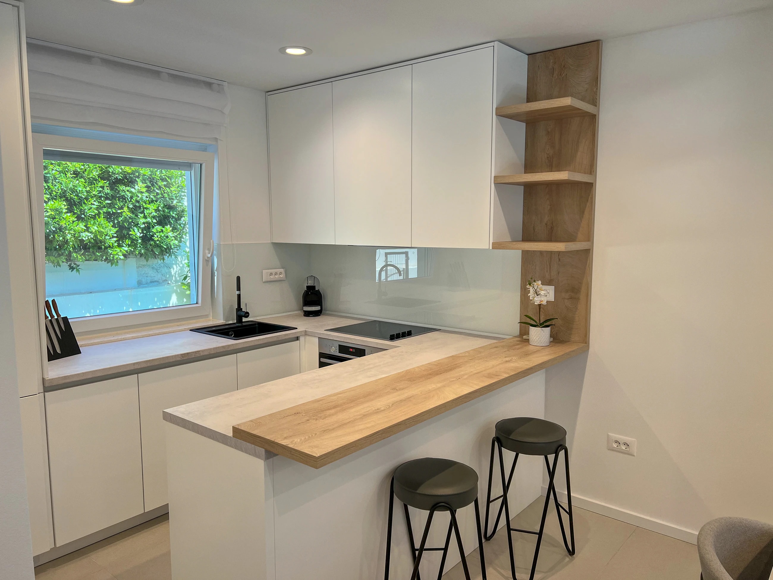 Contemporary kitchen with garden window at Three-Bedroom Apartment with Private Pool Near the Sea