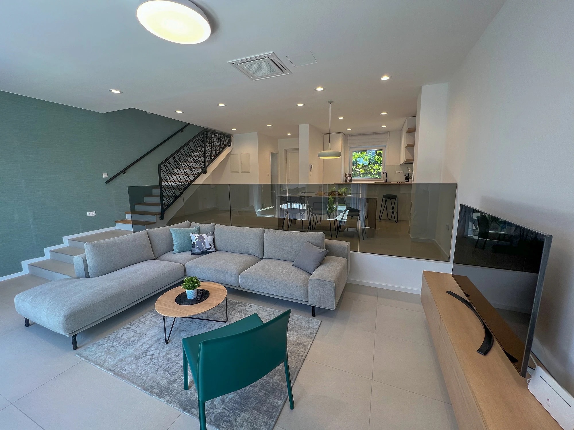 Spacious living area with garden doors at Three-Bedroom Apartment with Private Pool Near the Sea