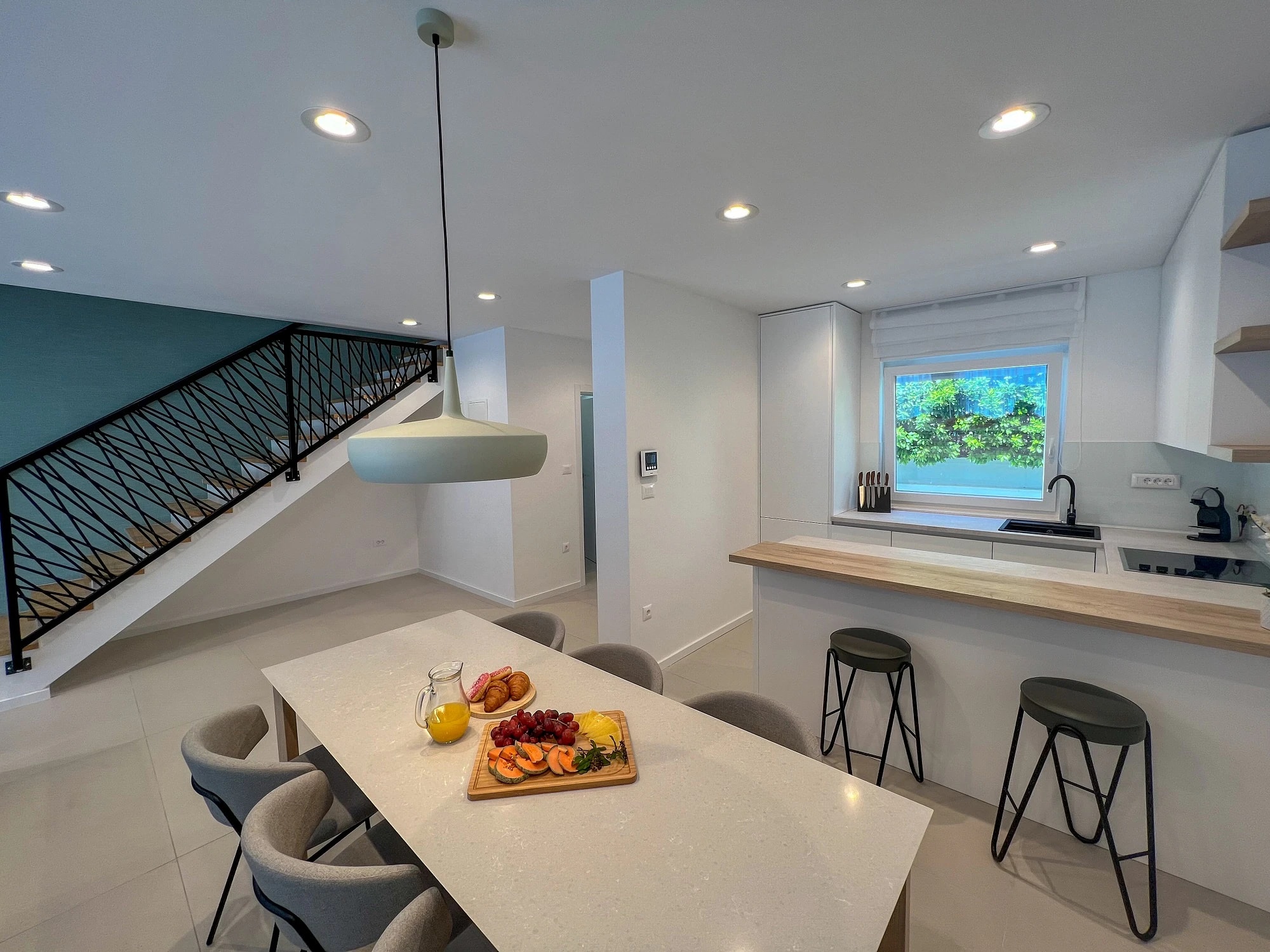 Kitchen island and dining area at Three-Bedroom Apartment with Private Pool Near the Sea