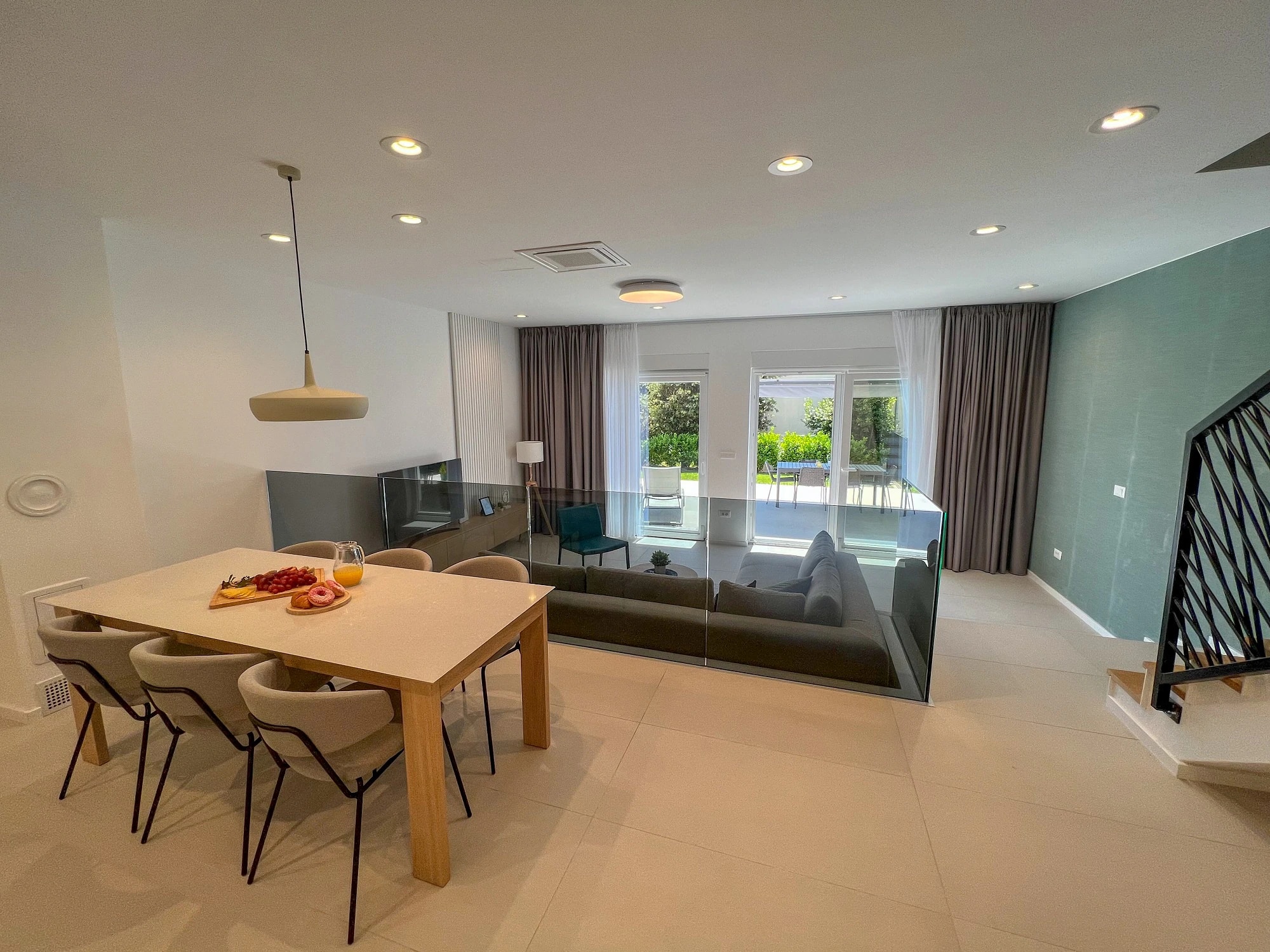 Open dining and living room at Three-Bedroom Apartment with Private Pool Near the Sea