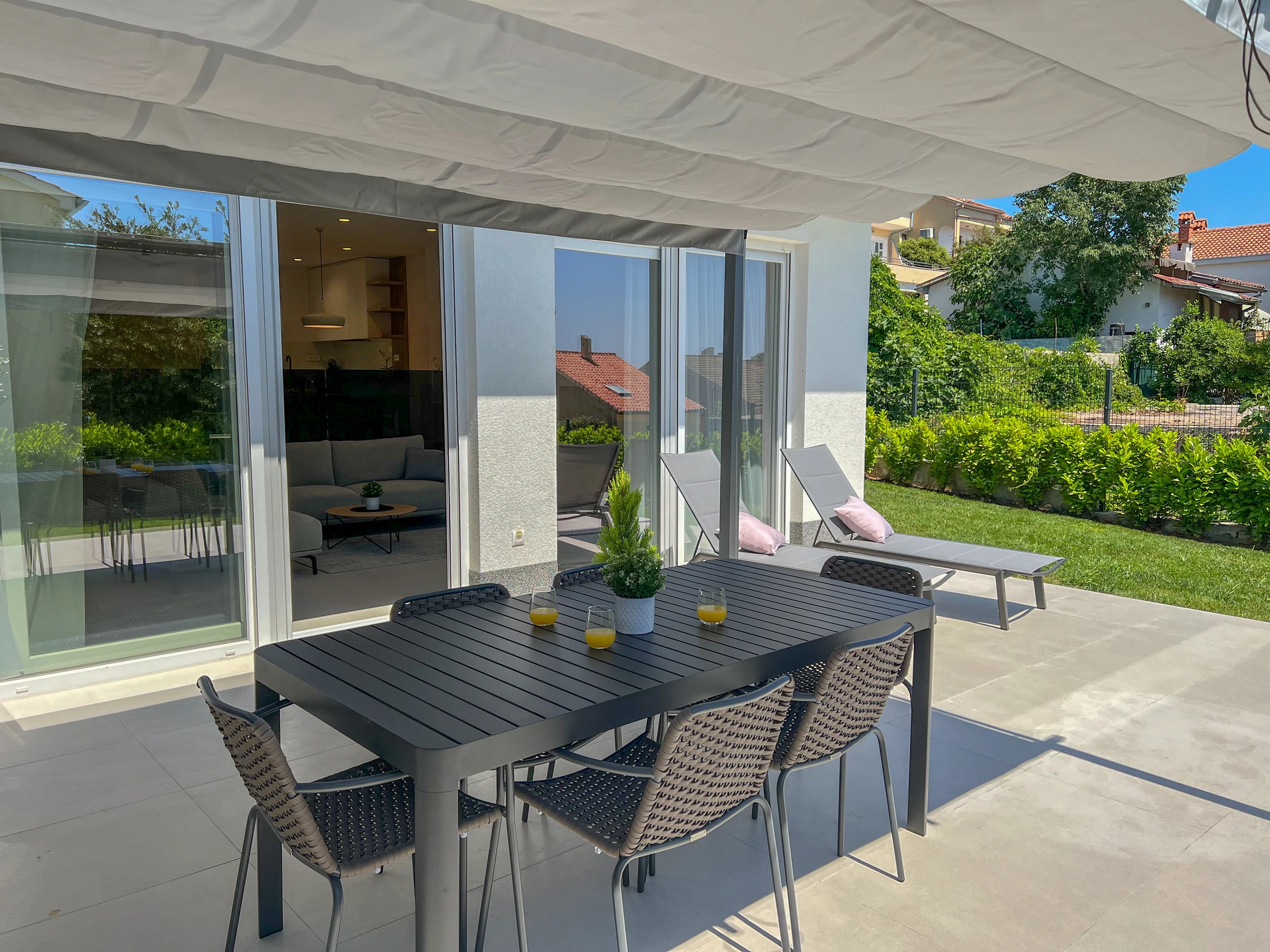 Shaded outdoor dining table beside the apartment