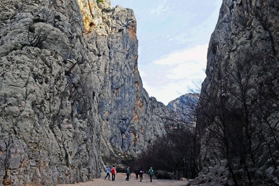 Hikers walking through the limestone canyon in Paklenica National Park