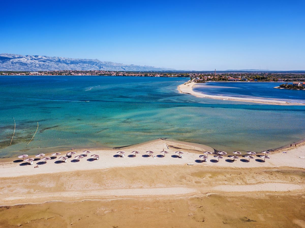 Queen's Beach in Nin with sandy shallows and the Velebit mountains
